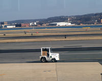 Ronald Reagan Washington National Airport (DCA) - Tug 63 with package - by Ronald Barker