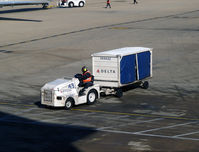 Ronald Reagan Washington National Airport (DCA) - Tug 43 with baggage cart - by Ronald Barker