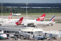 Orlando International Airport (MCO) - Busy Saturday at MCO - all international gates occupied - Gate 81 - Virgin A330, 83 - Air France 777, 85 -Virgin 747, 87 - Virgin 747 84 (not pictured) Lufthansa A340-600, 82 (not pictured) Virgin A330, 80 (not pictured) British 777 - by Florida Metal