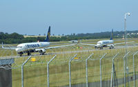 Edinburgh Airport, Edinburgh, Scotland United Kingdom (EGPH) - Ryanair B737-800's EI-DWC & EI-DAO Taxiing to runway 06,while in the back ground is G-RJXI Midland 66 landing  - by Mike stanners