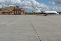 Venice Municipal Airport (VNC) - The FBO facility, Suncoast Cafe (excellent) and Tommy Hilfiger's jet on the ramp at Venice, FL - by Bob Simmermon