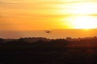 Swansea Airport, Swansea, Wales United Kingdom (EGFH) - Biplane arriving at sunset. - by Roger Winser