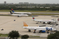 Tampa International Airport (TPA) - In this shot at Tampa Int'l you can see 4 different airlines - by Ron Coates