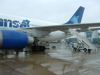 London Gatwick Airport - A busy wet morning on the ramp at London's Gatwick Airport - by Ron Coates