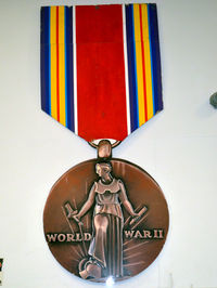 Stinson Municipal Airport (SSF) - Giant size US World War II Victory Medal at the Texas Air Museum - by Ronald Barker