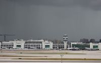 Miami International Airport (MIA) - Miami's American Airlines terminal with storm to the south - by Florida Metal