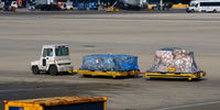 Chicago O'hare International Airport (ORD) - Baggage cart towed on the  ramp at O'Hare - by Ronald Barker