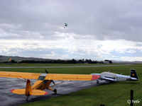 Fife Airport - Airfield scene looking west, parked aircraft and skydiver landing in the background at Glenrothes EGPJ - by Clive Pattle
