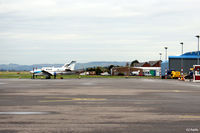 Dundee Airport, Dundee, Scotland United Kingdom (EGPN) - Wide expanse of apron available at Dundee Riverside. In the distance, looking west,  is a visiting M-KING and on the right the Loganair/Flybe maintenance hangar is visible - by Clive Pattle