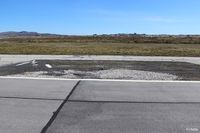 SFAL Airport - A darkened area of tarmac on the edge of the main runway at Port Stanley (SFAL) shows where repairs were made following the Vulcan Black Buck bombing sortie in May 1982.  - by Clive Pattle