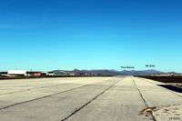 SFAL Airport - Lookg westwards down the runway at Port Stanley SFAL, with the airport terminal buildings on the left and the prominent mountains in the background, most of which featured heavily in the final battles in 1982. - by Clive Pattle
