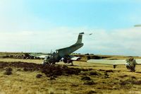 SFAL Airport - An historical view of Port Stanley SFAL immediately after the war in June 1982 showing a couple of wrecked Argentinian Pucara aircraft abandoned on the airfield. In the background some Argentinian Air Force equipment lies stockpiled - by Clive Pattle