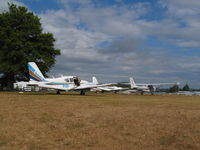 Ardmore Airport, Auckland New Zealand (NZAR) - view of grass parking area next to café.
Three sunair planes - visiting or possibly for sale? - by magnaman