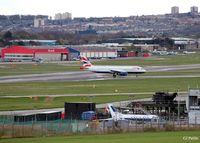 Aberdeen Airport, Aberdeen, Scotland United Kingdom (EGPD) - A newly arrived BA A320 taxies from the runway at Aberdeen EGPD. Note the fire training area (with ex RN Jetstream T.2 and ex RAF Jaguar GR.3) in the foreground and the parked Bond Helicopters and GA park in the background - by Clive Pattle