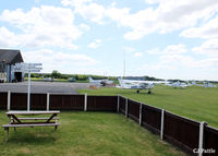 Sherburn-in-Elmet Airfield Airport, Sherburn-in-Elmet, England United Kingdom (EGCJ) - Looking across the apron from the clubhouse of Sherburn Aero Club. The staff are very welcoming and the food is de-lish. If you ask nicely and have a Hi-Vis jacket you may get airside and hangar access. - by Clive Pattle