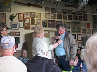 Santa Paula Airport (SZP) - Pat Quinn's Museum hangar on the occasion of his receiving the FAA Master Pilot Award for 50 years accident free-no violations flying. Arlys pinning her proud, well-deserved husband. - by Doug Robertson