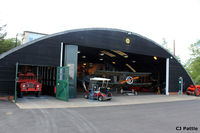 EGTH Airport - A view of one of the many hangars at The Shuttleworth Trust, Old Warden Airfield, offering a tantalising glimpse of some of the aviation occupants inside. - by Clive Pattle