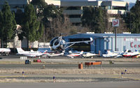 Buchanan Field Airport (CCR) - Pacific States Aviation offices, hangar and showroom @ Buchanan Field, Concord, CA on a windy January day (Hughes 369 hovering in foreground was with Bristow Academy) - by Steve Nation