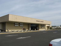 Oxnard Airport (OXR) - Oxnard Airport Terminal Building. No commercial commuter passenger flights have been offered to/from OXR since Summer 2010. The terminal only provides various rental vehicle services. Note the four blank placards. - by Doug Robertson