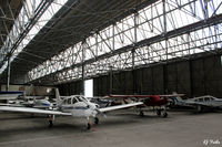 Perth Airport (Scotland) - General internal hangar view at Perth EGPT, highlighting the 1938 WWII roof construction, maximising on light. - by Clive Pattle