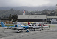 San Carlos Airport (SQL) - Line-up of locally-based Cirrus SR20 + SR22 aircraft @ San Carlos Airport, CA (viewed facing west)  - by Steve Nation