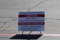 Santa Paula Airport (SZP) - Airport Caution Sign near Rwy 22/04 taxiway midfield Fuel Dock area - by Doug Robertson