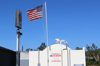 Santa Paula Airport (SZP) - Flag at SZP Fuel Dock showing stiff Santa Ana wind. Rwy 04 in use today. - by Doug Robertson
