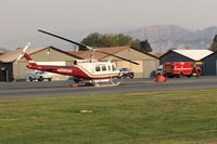 Santa Paula Airport (SZP) - N205GH  1965 Bell UH-1H IROQUOIS, Lycoming T53L-703 Turbo-shaft, Restricted class. at SZP THOMAS Fire Base. NOTE Smoky Sky. - by Doug Robertson