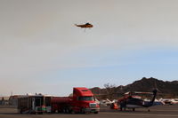 Santa Paula Airport (SZP) - CROMAN helicopter with Phos-Chek sling load dumped, returning to SZP Firebase. Note smoky sky. - by Doug Robertson