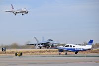 Boise Air Terminal/gowen Fld Airport (BOI) - A Piper on Taxiway Foxtrot while an EA-18G takes off on RWY 10R and American Airlines lands on RWY 10L. - by Gerald Howard