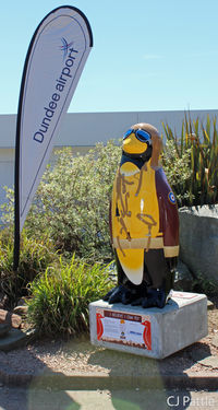 Dundee Airport, Dundee, Scotland United Kingdom (EGPN) - A penguin statue dressed in WWII flying gear has appeared at the Airport Terminal at Dundee, EGPN. It is one of 80 that have been hatched around Dundee City as a charity fundraiser and placed at key locations. This one is called 'I believe I can fly' - by Clive Pattle