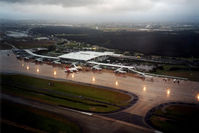 Brisbane International Airport, Brisbane, Queensland Australia (YBBN) - Low Res Overview of a dark and wet Brisbane International Airport YBBN taken during the dusk departure of QantasLink Shorts S360-300 VH-SUM, heading for Bundaberg YBUD on 16Jan2002. - by Walnaus47